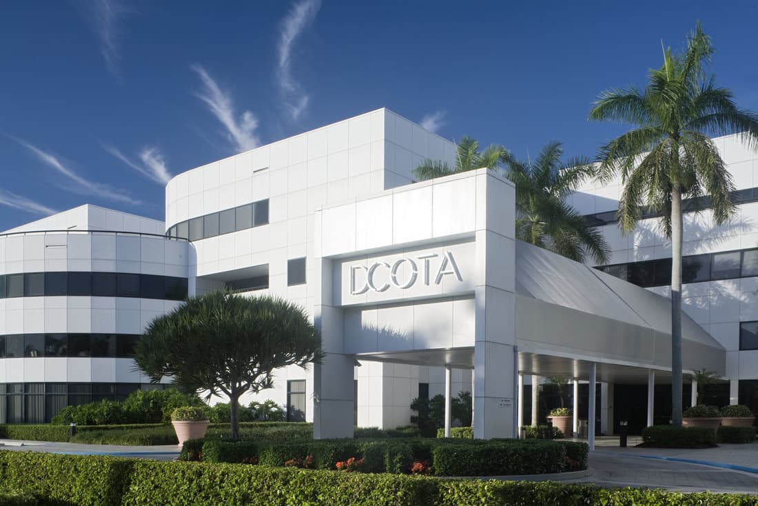 Design center exterior with palms and glass facade