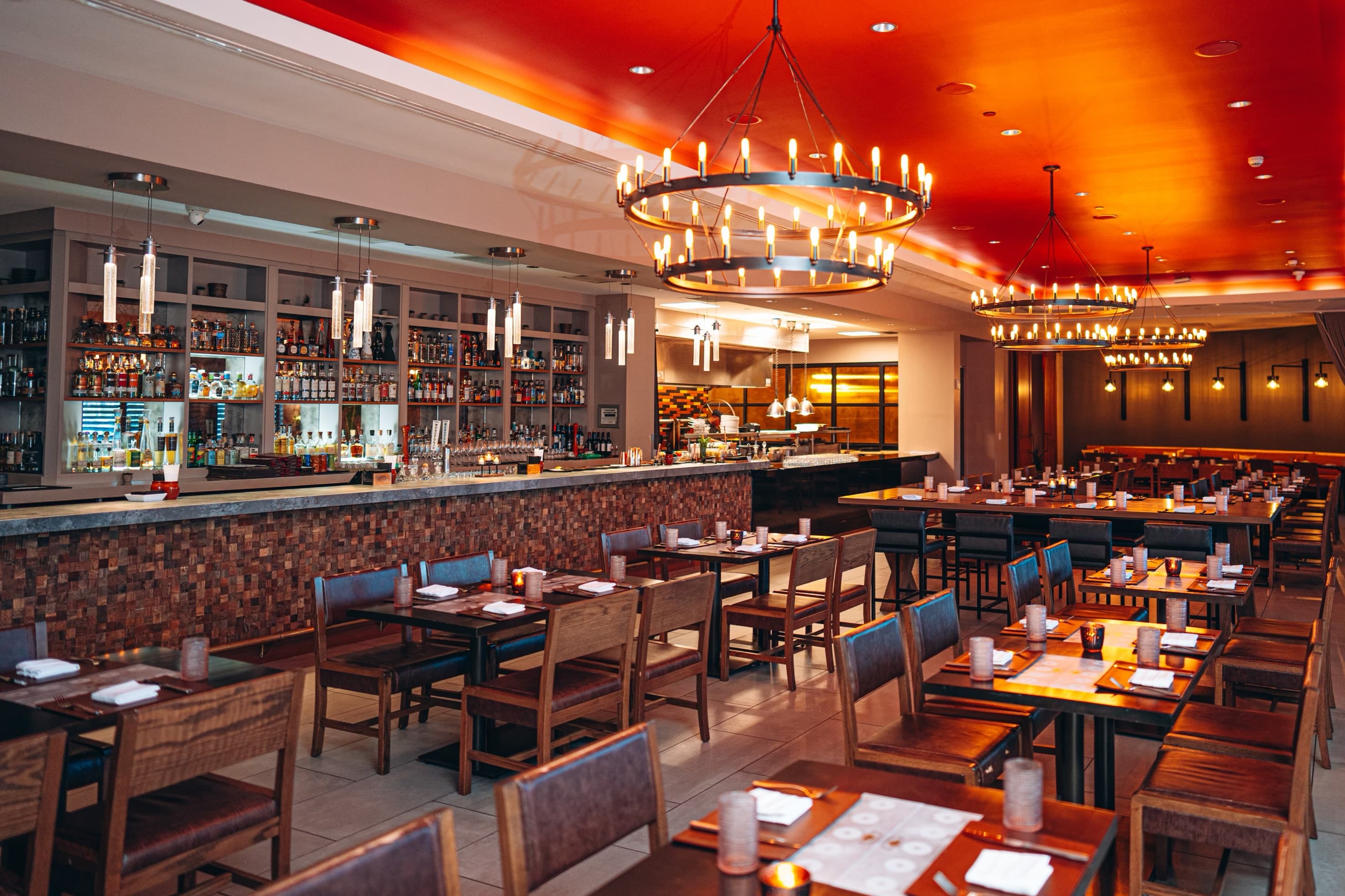 Main dining room with warm lighting and table seating